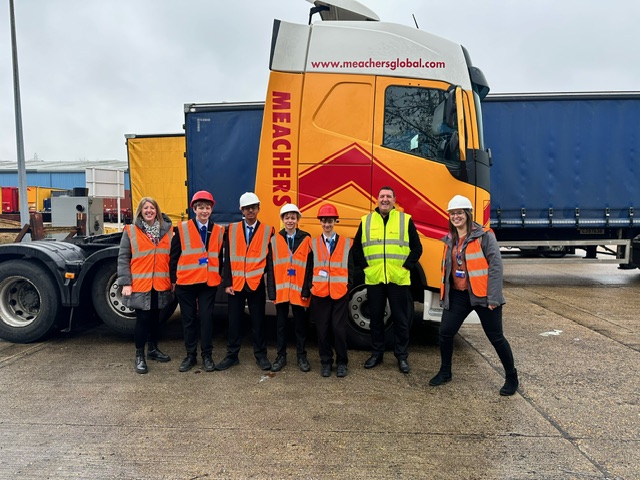 National Apprenticeship Week - image of people with high visibility clothing and hard hats in front of an orange and red lorry
